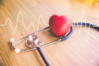 Stethoscope wrapped around plastic heart 